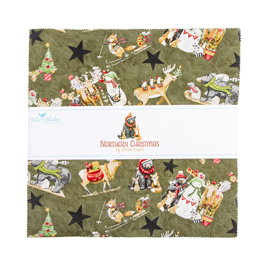 A fabric layer cake with a repeating Christmas-themed print on an olive green background, featuring Santa Claus, reindeer, sleighs, stars, and holiday motifs. A white paper band across the center reads 'Northern Christmas Fabrics' with a small Santa illustration.