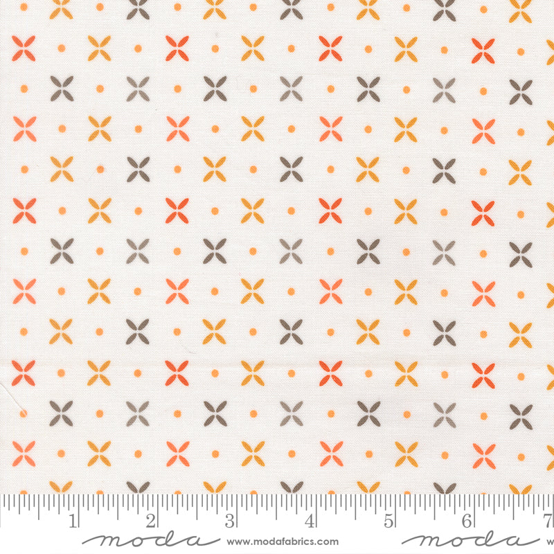 Fabric swatch with yellow, orange, and gray x's and orange dots on a white background.