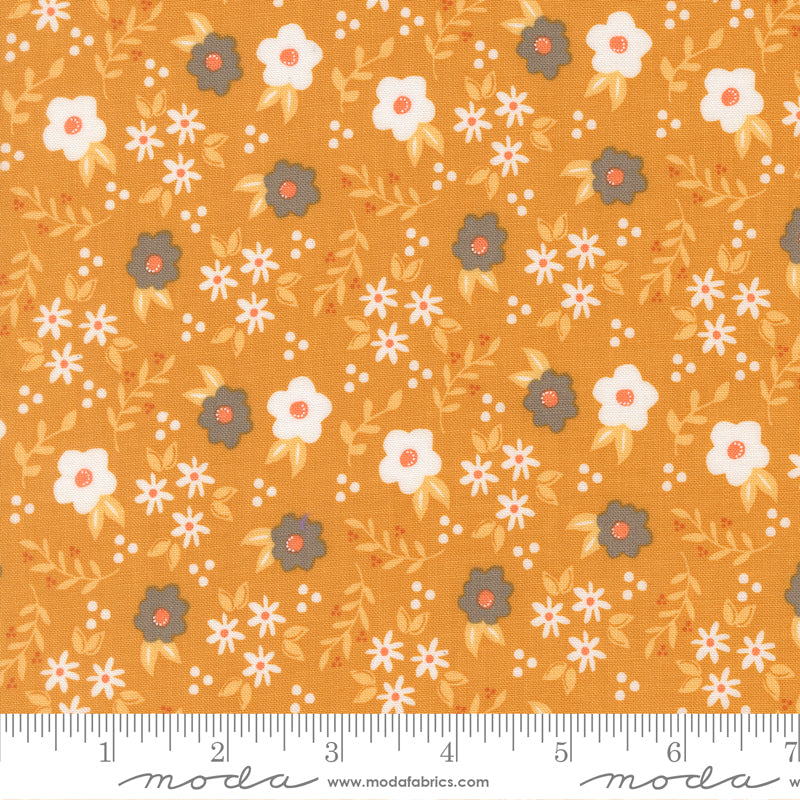 Orange fabric with white and gray flowers and light orange foliage.