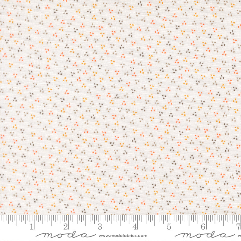 Fabric swatch with a white background and orange, yellow, green and gray dots in the shapes of triangles.