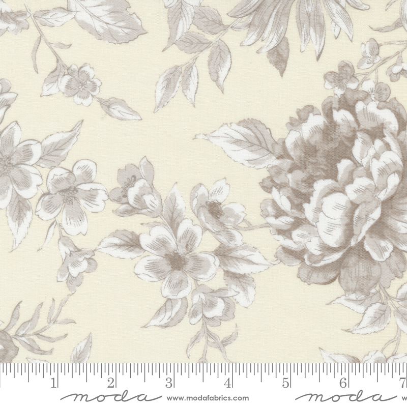 Floral pattern fabric with a ruler for scale on a beige background