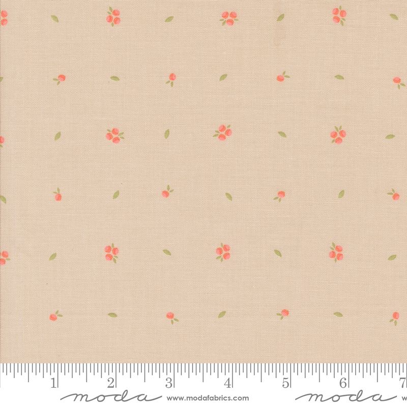 Beige fabric with a small-scale repeating pattern of coral-red flowers and green leaves, shown with a measuring ruler along the bottom edge.