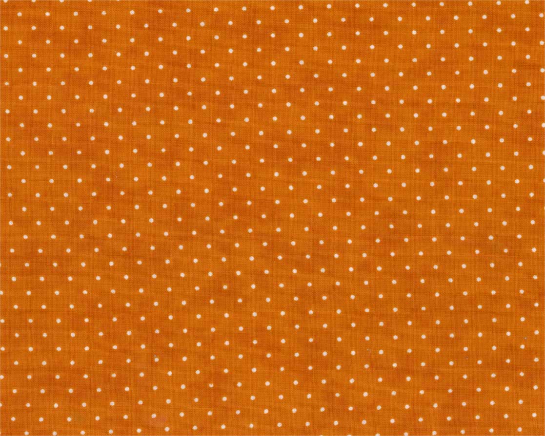 A close-up of orange fabric with a repeating pattern of small white polka dots.