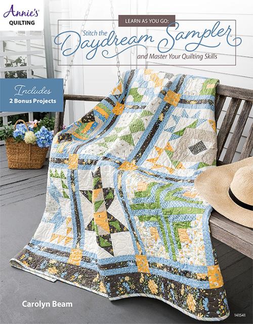 Quilt pattern cover for 'Annie's Quilting: Stitch the Daydream Sampler' by Carolyn Beam, featuring a colorful patchwork quilt draped over a wooden bench on a porch, with a straw hat and hanging swing in the background.