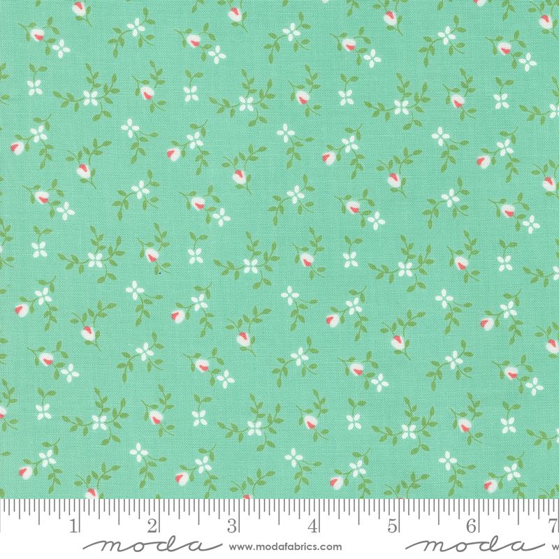 Mint green fabric with a repeating pattern of small white flowers, green leaves, and pink rose buds, shown with a measuring ruler along the bottom edge.