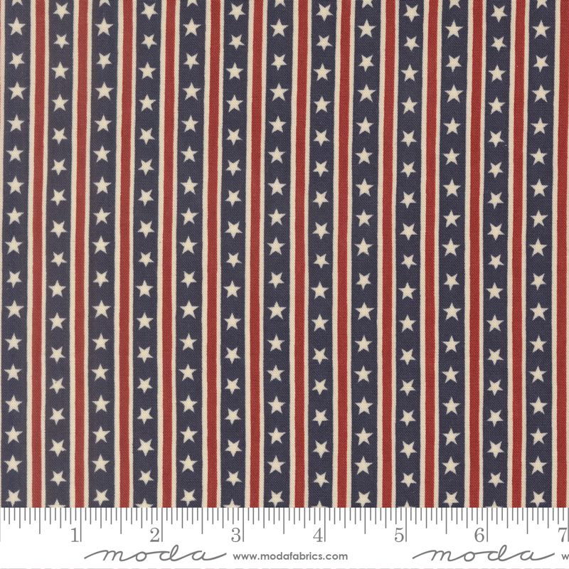 Patriotic American flag fabric pattern with vertical red and white stripes and white stars on a navy blue background, shown with a ruler at the bottom for scale. The brand name 'moda' is visible on the ruler watermark.