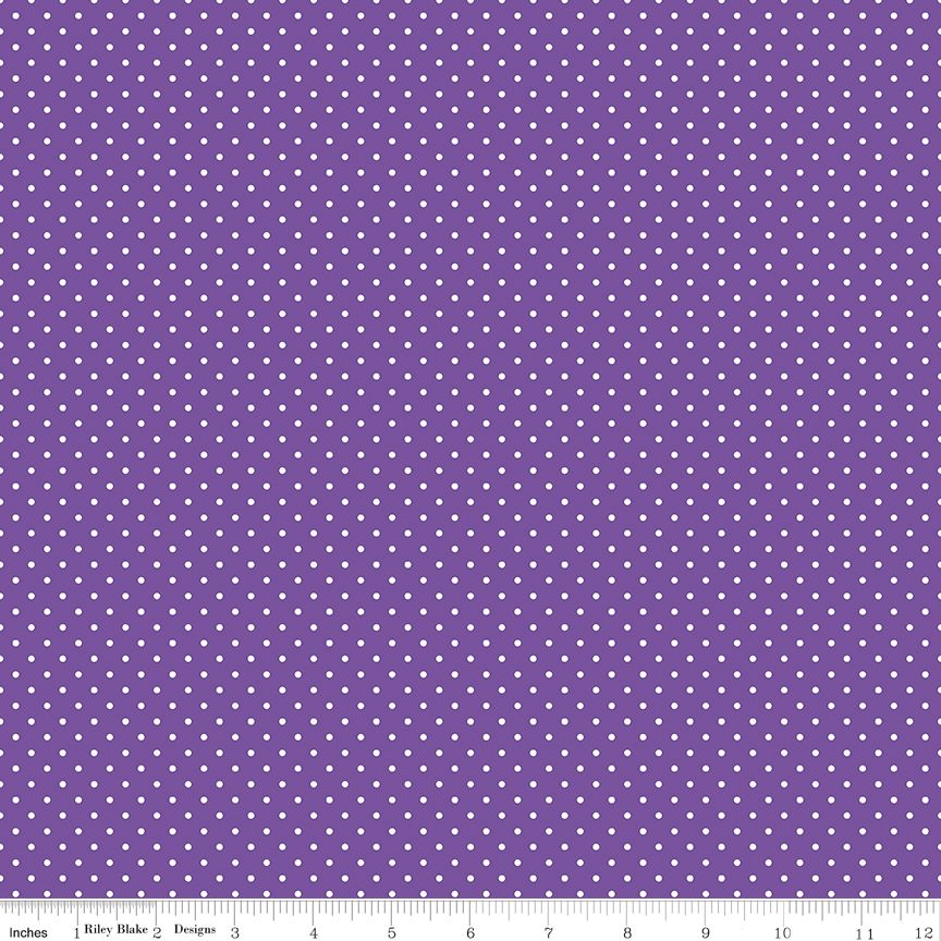 Purple fabric with a repeating pattern of small white dots, shown with a measuring ruler along the bottom edge.