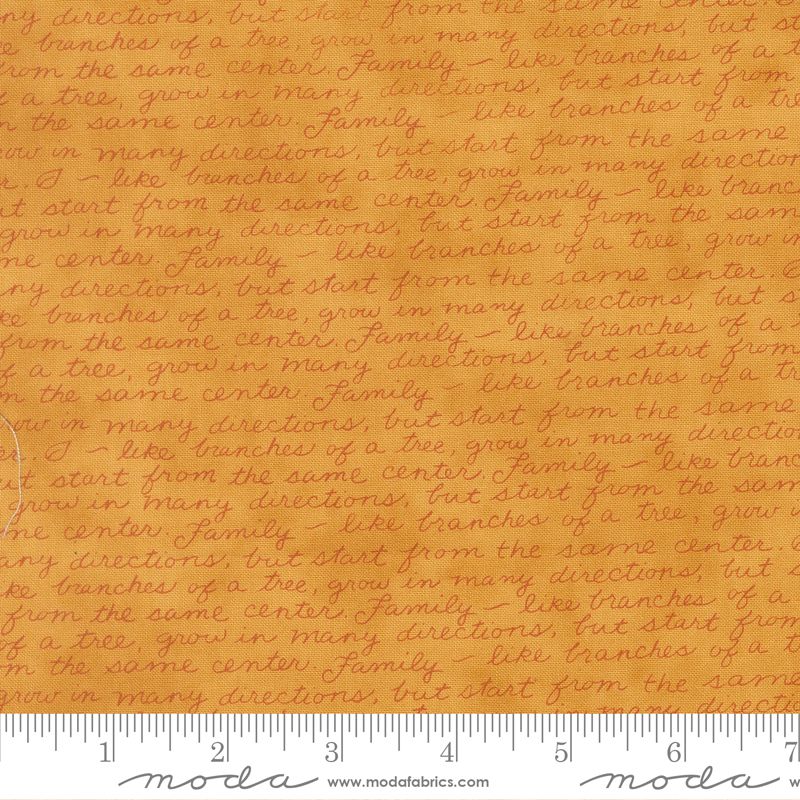 Textured gold fabric with printed text and a ruler at the bottom for scale.