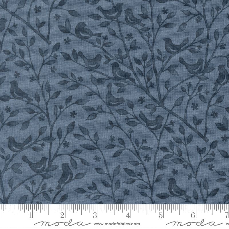 Fabric pattern with birds and branches on a blue background, featuring Moda label.