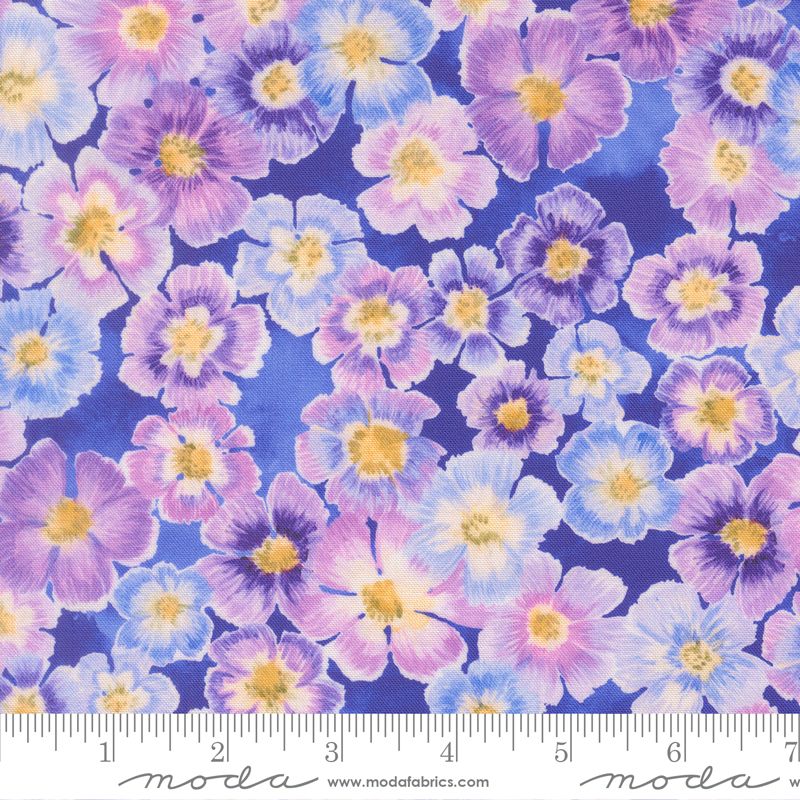 Floral fabric pattern with purple, blue, and pink flowers on a blue background, featuring Moda label.