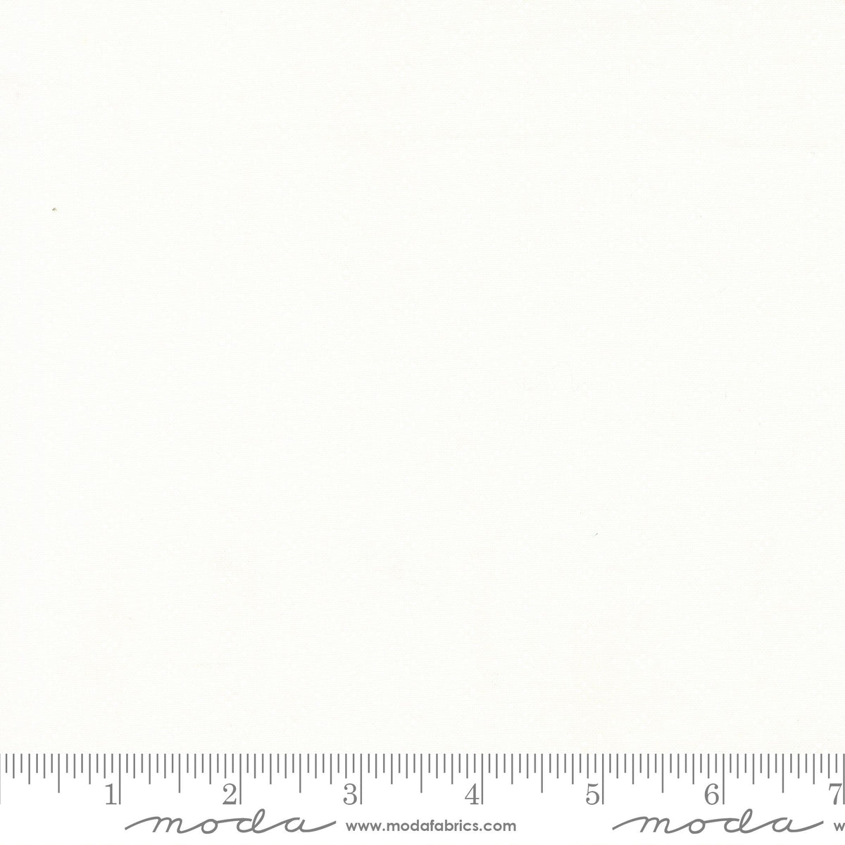 A white-on-white eyelet pattern fabric with a gray ruler printed along the bottom edge and the Moda Fabrics logo and website printed below the ruler.