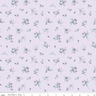 Lavender floral fabric with a repeating pattern of small blue and green flowers and leaves, shown with a white ruler along the bottom edge.