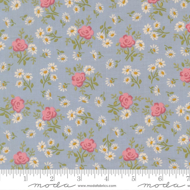 Floral pattern with pink roses and white daisies on a blue background, featuring Moda label.