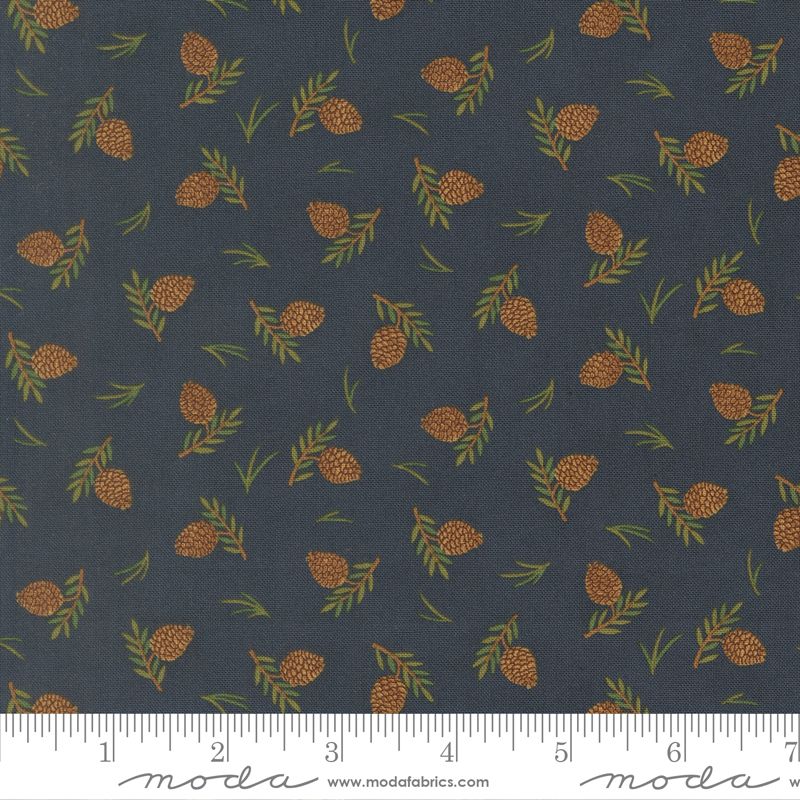 Fabric pattern with pinecones and leaves on a dark blue background, featuring Moda label.