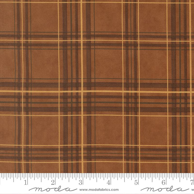 Brown plaid fabric with a ruler at the bottom for scale, featuring the Moda Fabrics logo.