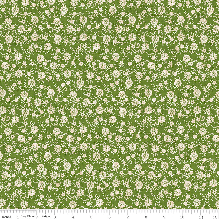 Green fabric with sprigs of flowers on a textured background.