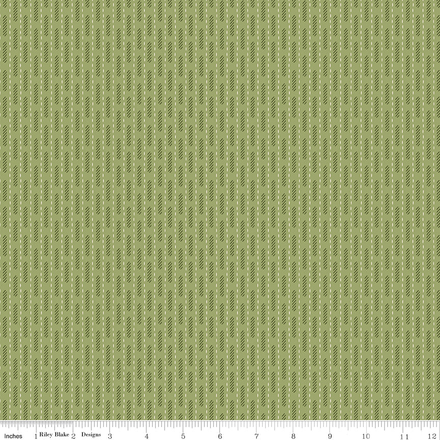 Green fabric with stripes made of dashes and slashes.