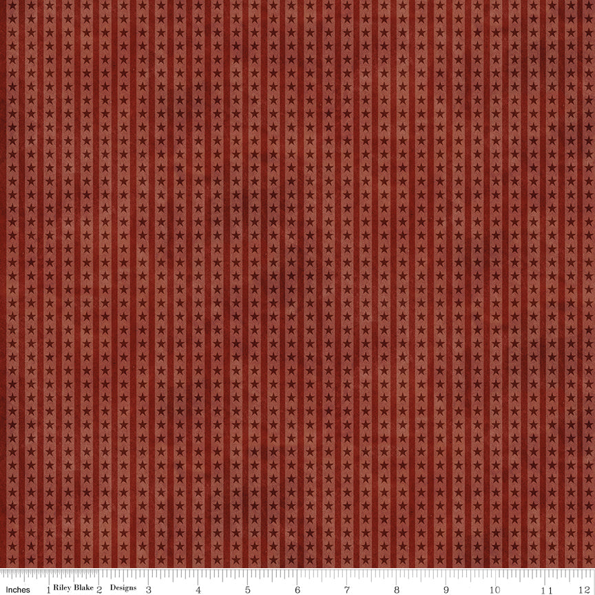 A close-up of a fabric pattern featuring a repeating vertical stripe design in warm rust red and brown tones, with a white measurement ruler visible along the bottom edge.