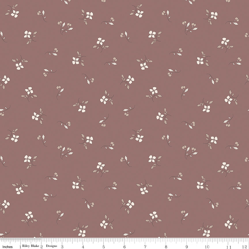 Red fabric with scattered sprigs of flowers and leaves.