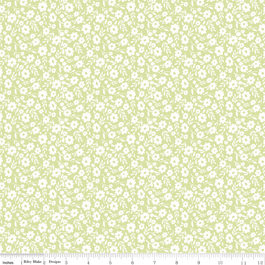 Green fabric with white sprigs of flowers.