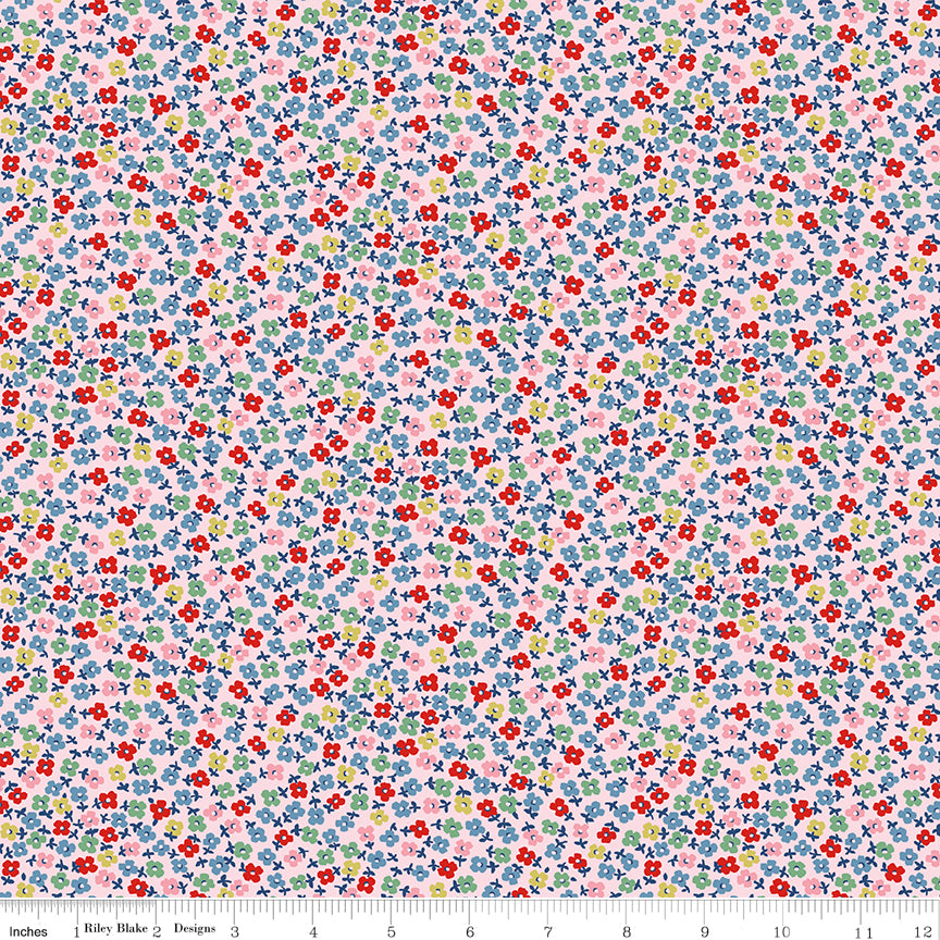 Fabric swatch with teeny green, blue, red, yellow, and pink flowers on a pale pink background.