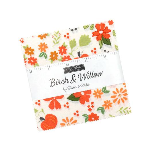 Front of a Birch & Willow fabric charm pack.  White background with orange flowers and pumpkins and green foliage. 