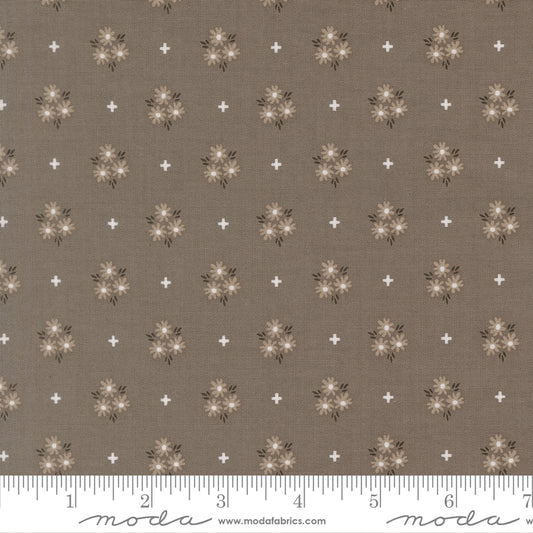 Slate background fabric with gray and white flowers and white plus signs. 