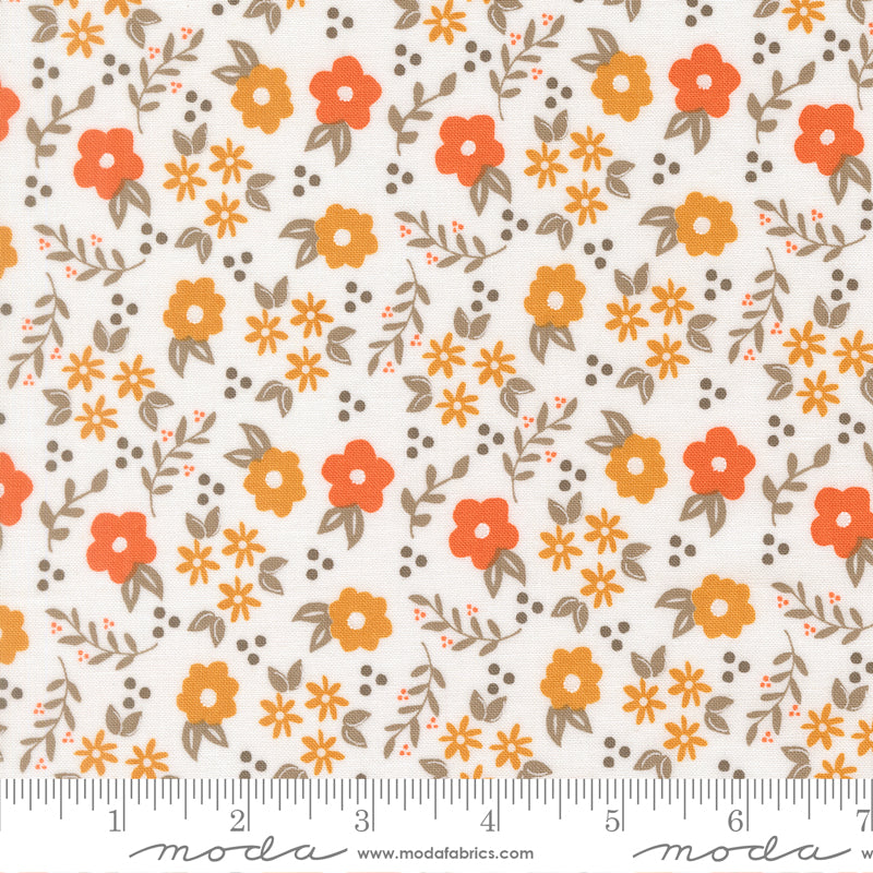 White fabric with orange and yellow flowers and gray leaves and dots. 