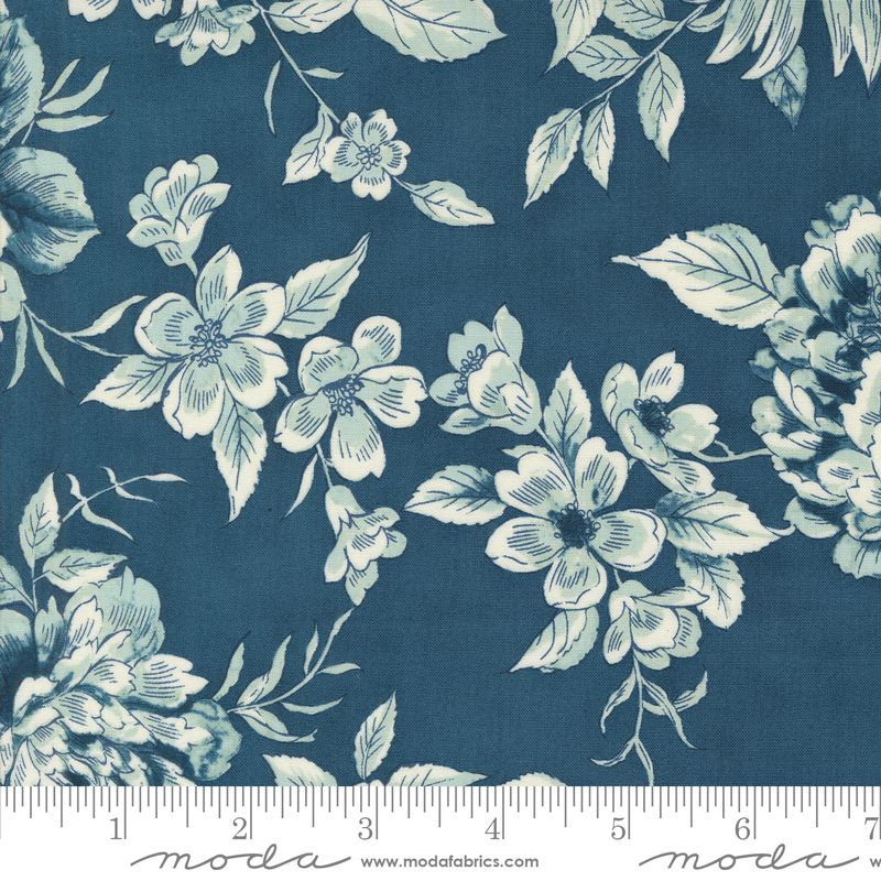 Floral pattern fabric swatch with a ruler at the bottom on a blue background