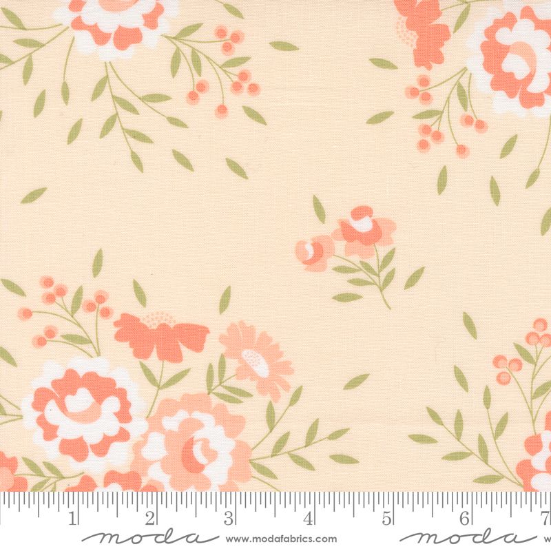 Floral fabric pattern on a pale pink background with coral-pink flowers, white accents, and green leaves, shown with a ruler at the bottom for scale. The brand Moda Fabrics is visible at the bottom.