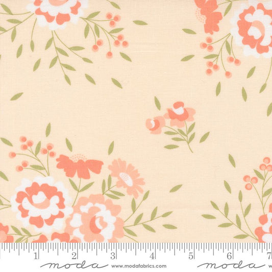 Floral fabric pattern on a pale pink background with coral-pink flowers, white accents, and green leaves, shown with a ruler at the bottom for scale. The brand Moda Fabrics is visible at the bottom.