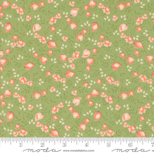 A repeating fabric pattern featuring small pink birds, coral flowers, and white berries on a sage green background, with a white ruler along the bottom edge showing measurements. The brand name 'moda' is printed on the ruler.