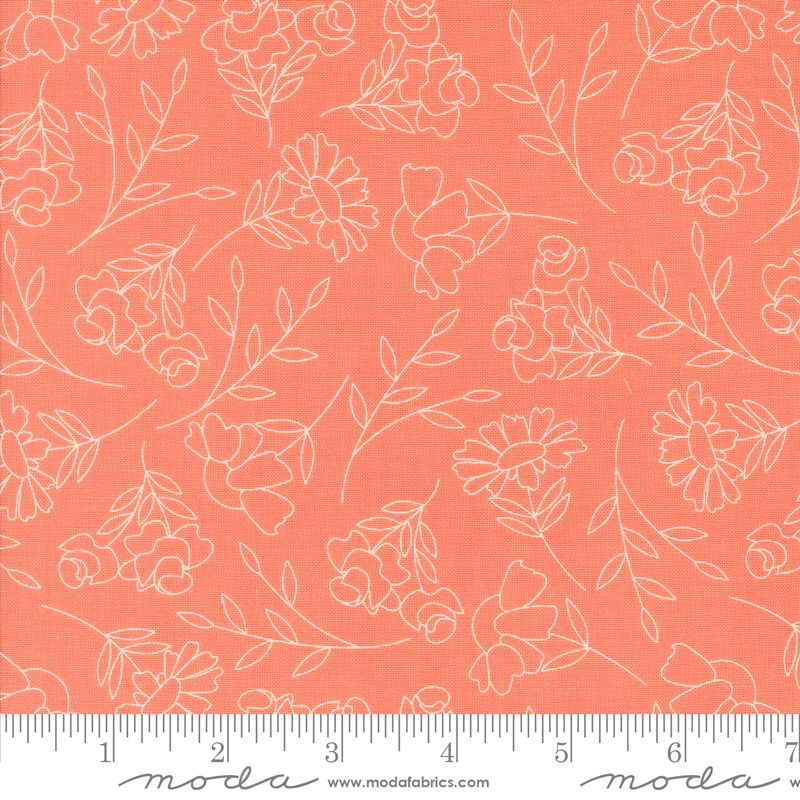 Coral pink fabric with a white floral line pattern, shown flat with a measuring ruler along the bottom edge.
