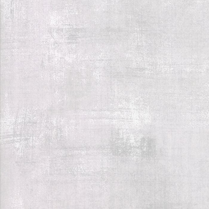 A close-up of a light gray textured surface with subtle horizontal and vertical brushstroke or woven-like variation.
