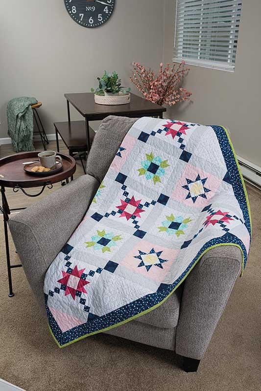Colorful quilt draped over a chair in a living room setting