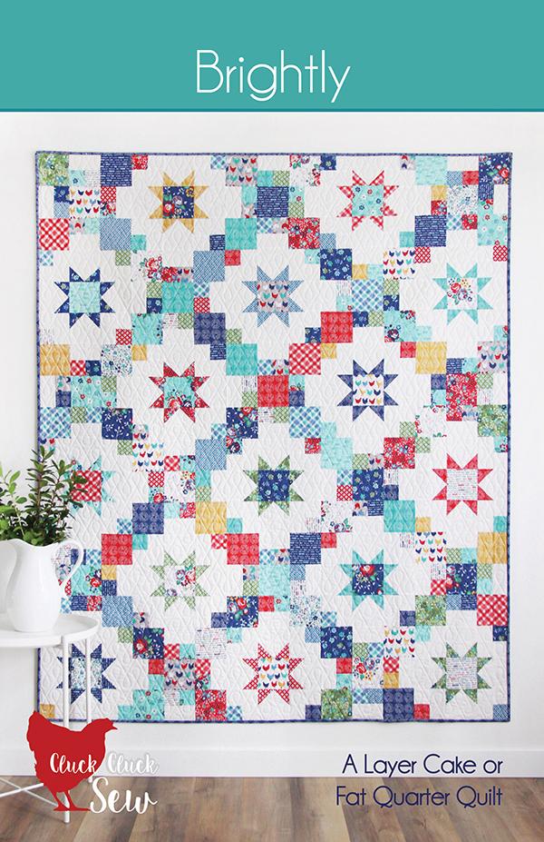 Brightly pattern cover showing a colorful quilt with star patterns on a white background.  Pattern by Cluck Cluck Sew.