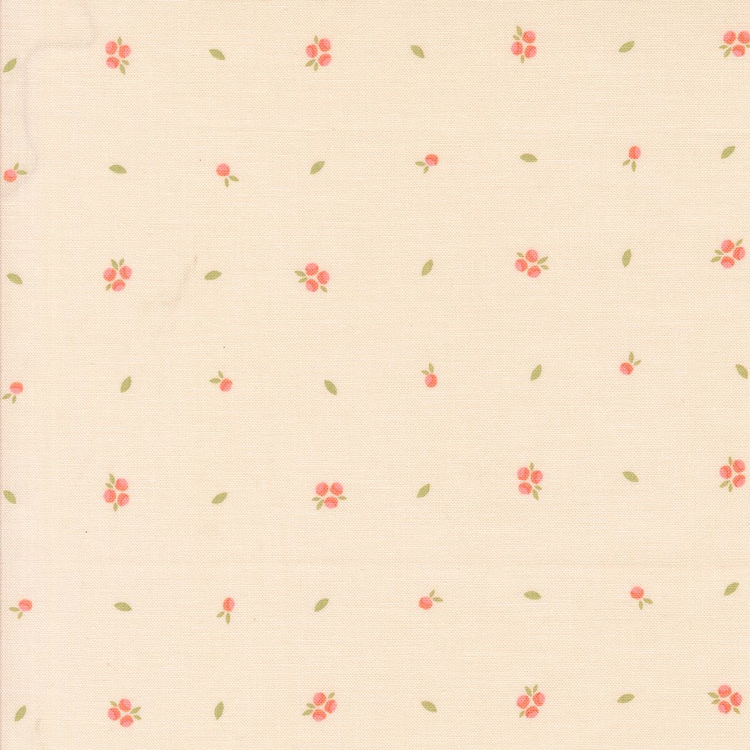 A close-up of a cream-colored fabric with a delicate repeating pattern of small pink flowers and tiny green leaves.