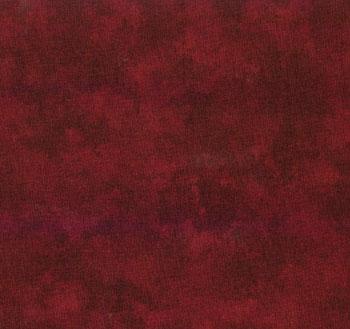 A close-up of a mottled dark red fabric texture with subtle tonal variation.