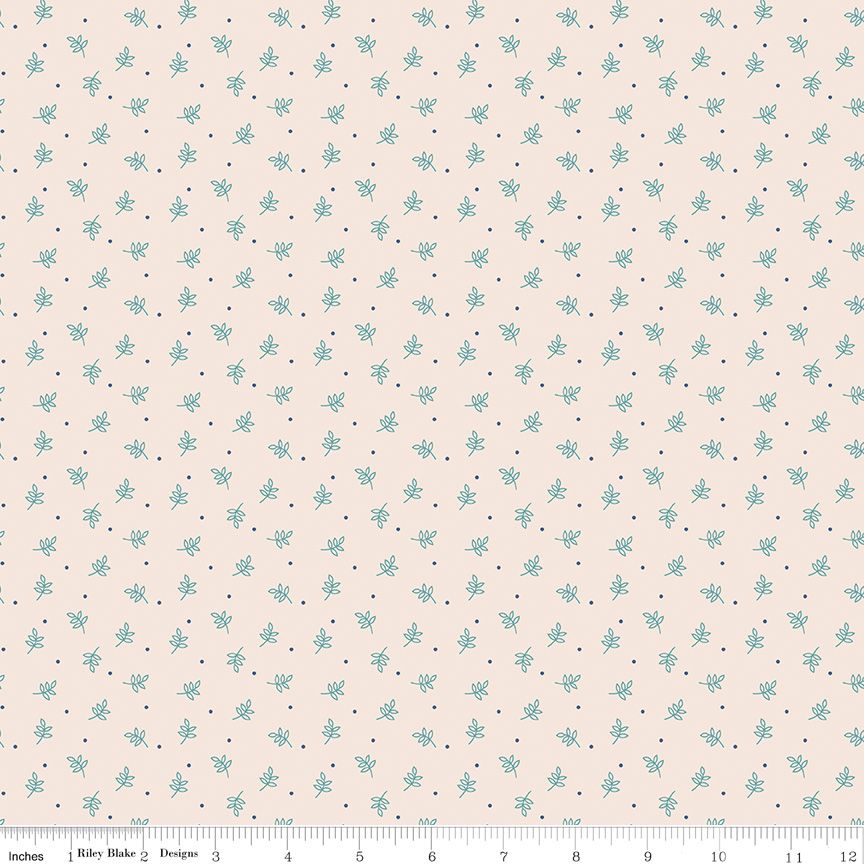 A repeating fabric pattern featuring small light blue floral motifs and tiny dark blue dots on a warm cream background, with a ruler along the bottom edge showing measurements.