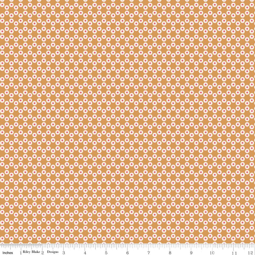 Fabric with small white circles with red centers on a gold background