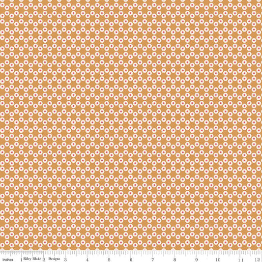 Fabric with small white circles with red centers on a gold background