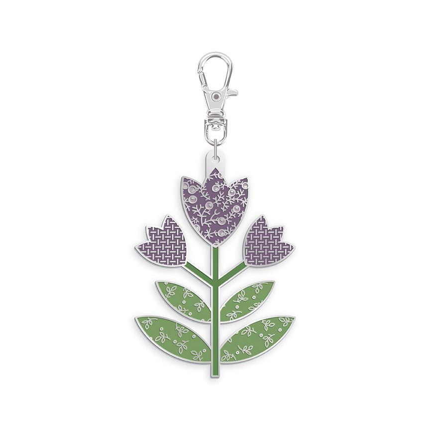 A metal flower-shaped keychain charm featuring three purple patterned petals and green patterned leaves, attached to a silver lobster clasp, shown on a plain white background.