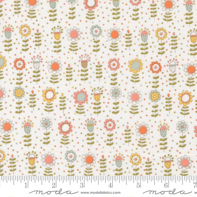 A repeating floral fabric pattern on a warm off-white background, featuring retro-style flowers in coral, orange, yellow, sage green, and light blue-gray, with small scattered polka dots. A ruler along the bottom edge shows scale, and the Modas Fabrics watermark is visible at the bottom.