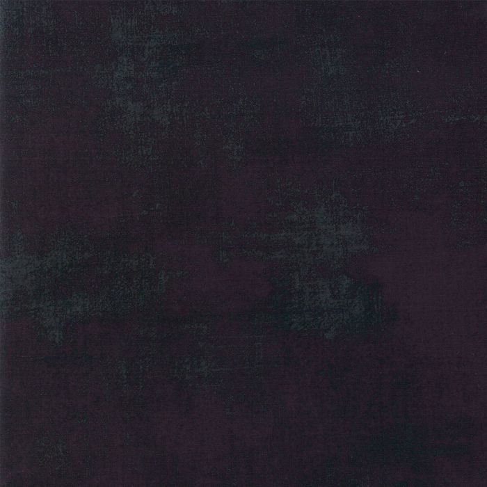 A close-up of a dark black textured material swatch with subtle tonal variation.