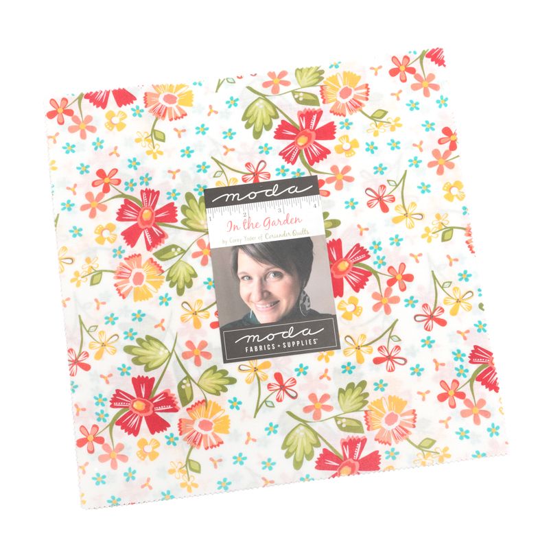 Floral patterned fabric layer cake with Moda label on a white background