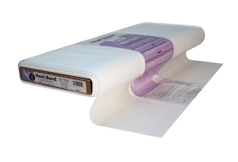 A roll of Heat-Bond Lite film, partially unrolled to show its clear, semi-translucent material and purple label packaging, set against a plain white background.