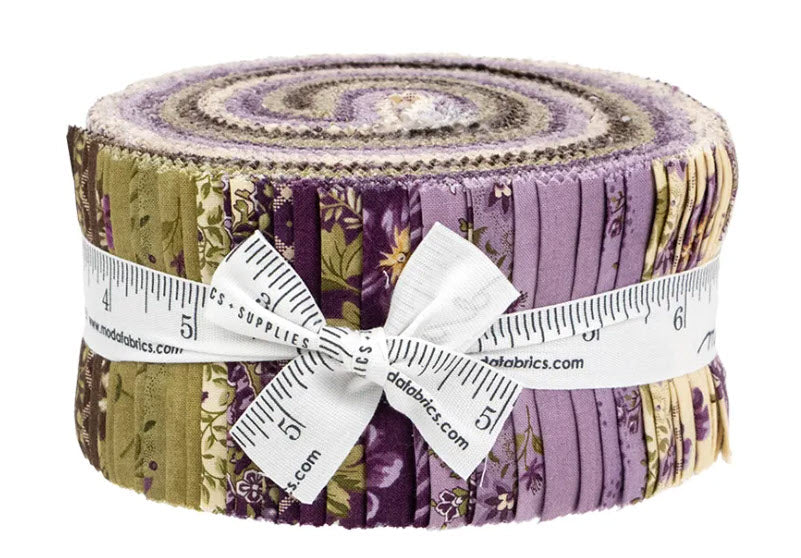 A roll of fabric cut pieces tied with a white measuring ribbon, showing a multicolor pattern of purple, green, and beige floral and striped fabrics on a white background.