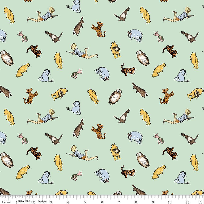 A repeating fabric pattern featuring classic Winnie the Pooh characters like Pooh, Tigger, Piglet, Eeyore, and Christopher on a pale mint green background, with a ruler at the bottom showing scale.