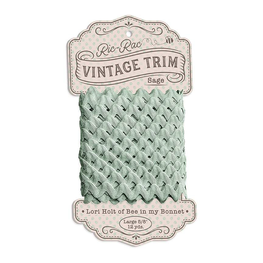 Sage green vintage trim on a white background with a label.