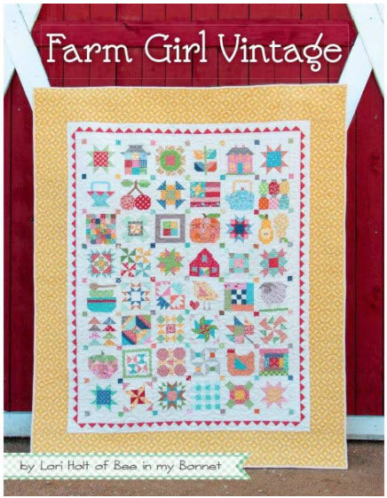 A vintage-style quilted patchwork pattern book with a yellow border and a multicolor central panel featuring various folk-style quilt motifs, displayed against a red barn door background with the text 'Farm Girl Vintage' at the top.
